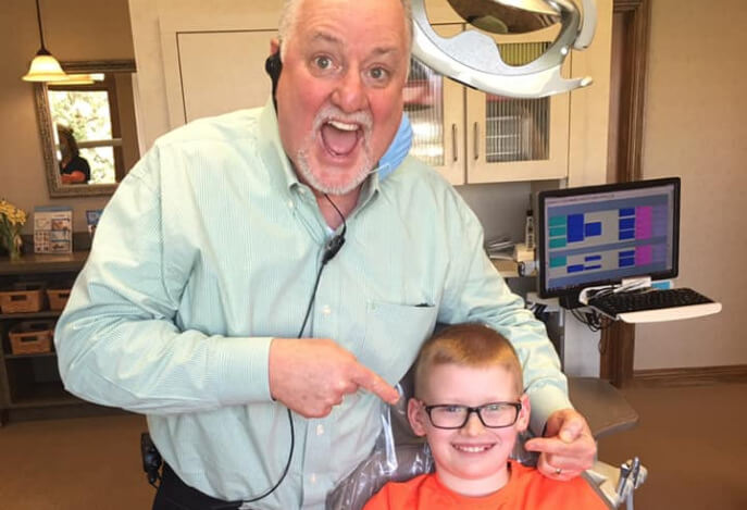 happy-dentist-showing-off-kids-teeth